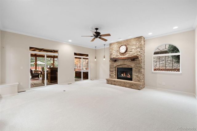 a view of an empty room with a fireplace and a window