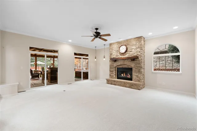 a view of an empty room with a fireplace and a window