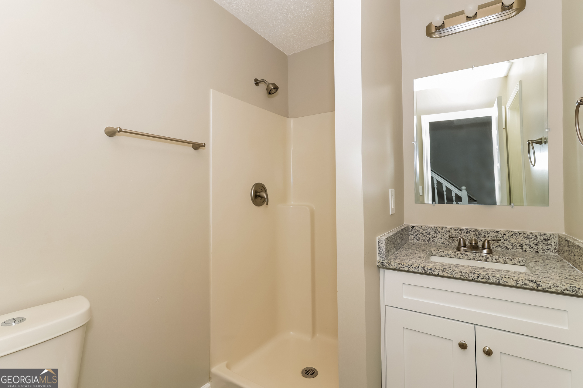 5319 Creekview Way Morrow, GA 30260 - Photo 12 of 17 a bathroom with a granite countertop sink a mirror and a shower