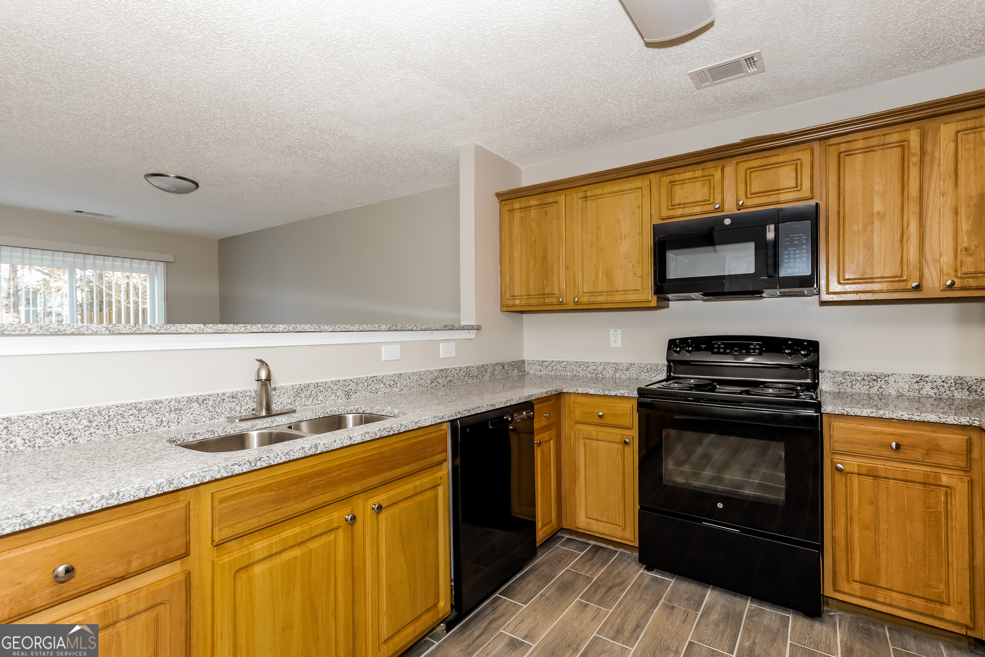5319 Creekview Way Morrow, GA 30260 - Photo 4 of 17 a kitchen with stainless steel appliances granite countertop a sink stove and microwave