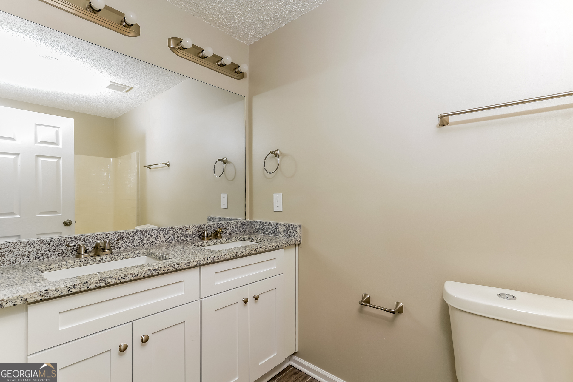 5319 Creekview Way Morrow, GA 30260 - Photo 8 of 17 a bathroom with a granite countertop sink a toilet and a mirror