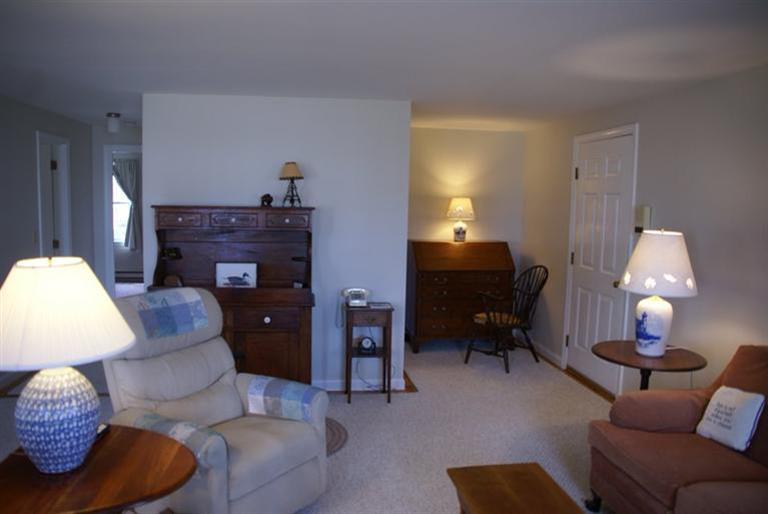 95 Depot Road, Unit 14 Chatham, MA 02633 - Photo 2 of 11 a living room with furniture and a lamp