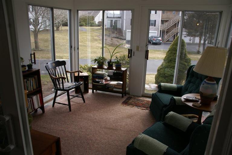 95 Depot Road, Unit 14 Chatham, MA 02633 - Photo 3 of 11 a living room with furniture and a floor to ceiling window