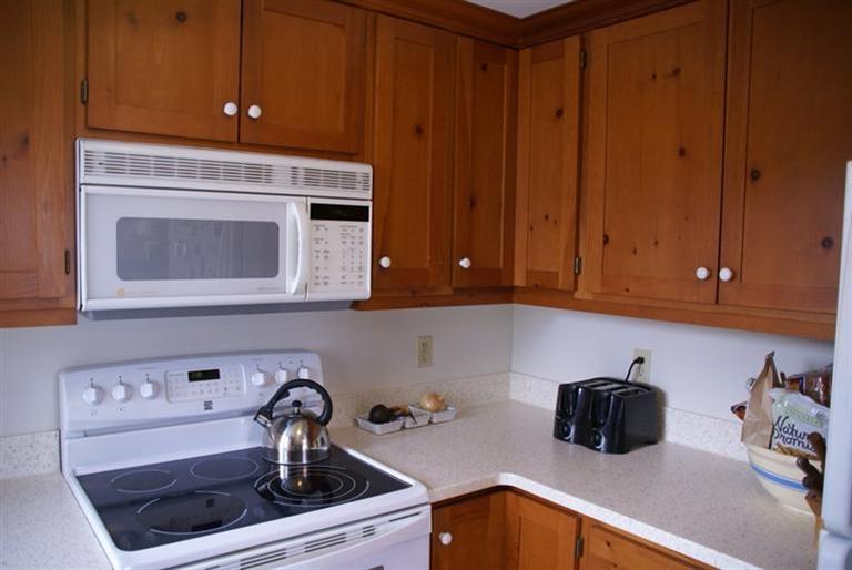 95 Depot Road, Unit 14 Chatham, MA 02633 - Photo 7 of 11 a kitchen with a stove and a microwave