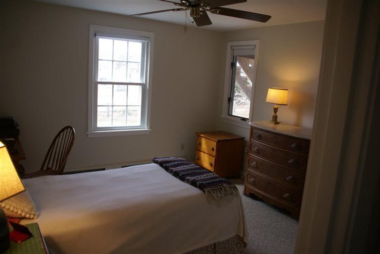 95 Depot Road, Unit 14 Chatham, MA 02633 - Photo 9 of 11 a bedroom with a bed and a dresser next to a window