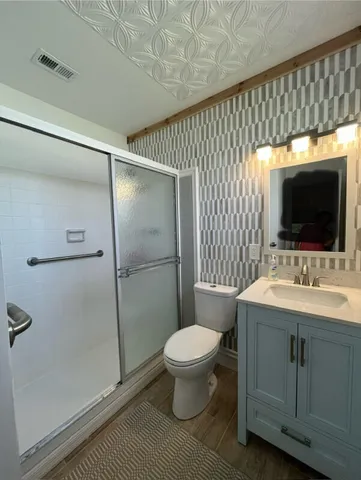 a bathroom with a sink toilet and shower