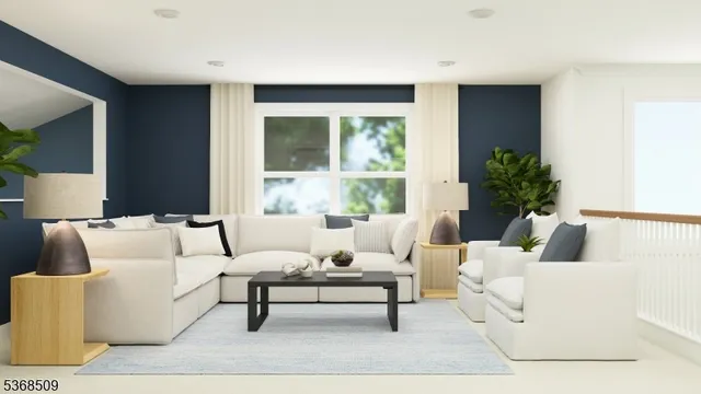 a living room with furniture and a large window with garden view