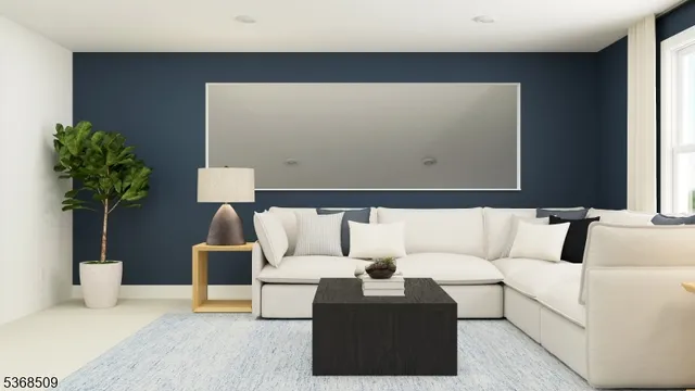 a living room with furniture and a potted plant