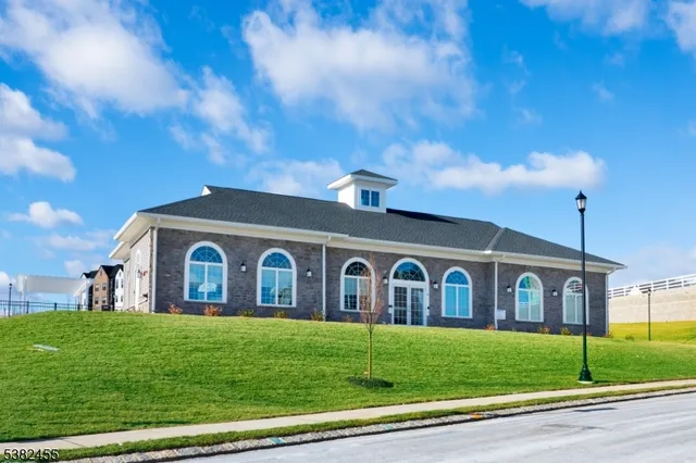 a view of a large house with a big yard and large trees