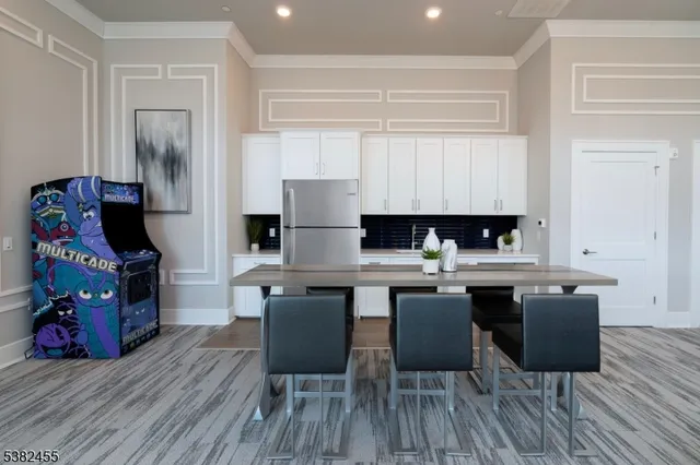 a kitchen with a table chairs and a wooden floor