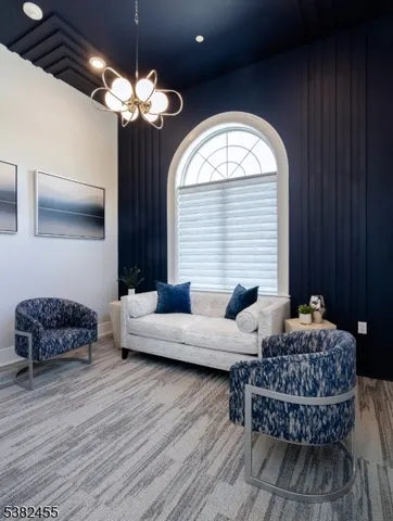 a living room with furniture and a chandelier
