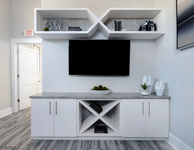 a kitchen with a sink a microwave and cabinets