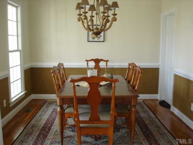 527 Competition Road Raleigh, NC 27603 - Photo 4 of 7 a view of a dining room with furniture window and wooden floor