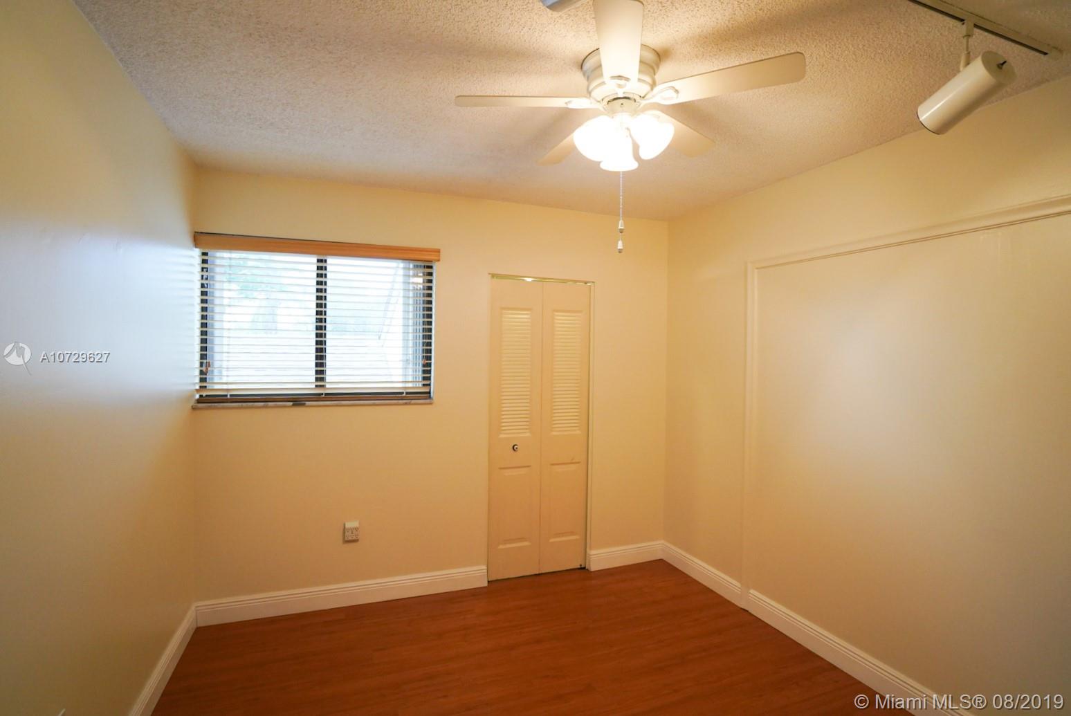 11501 Southwest 109th Road, Unit 13D Miami, FL 33176 - Photo 11 of 30 Bedroom 1 - Ceiling Fan, Window, Track Lighting