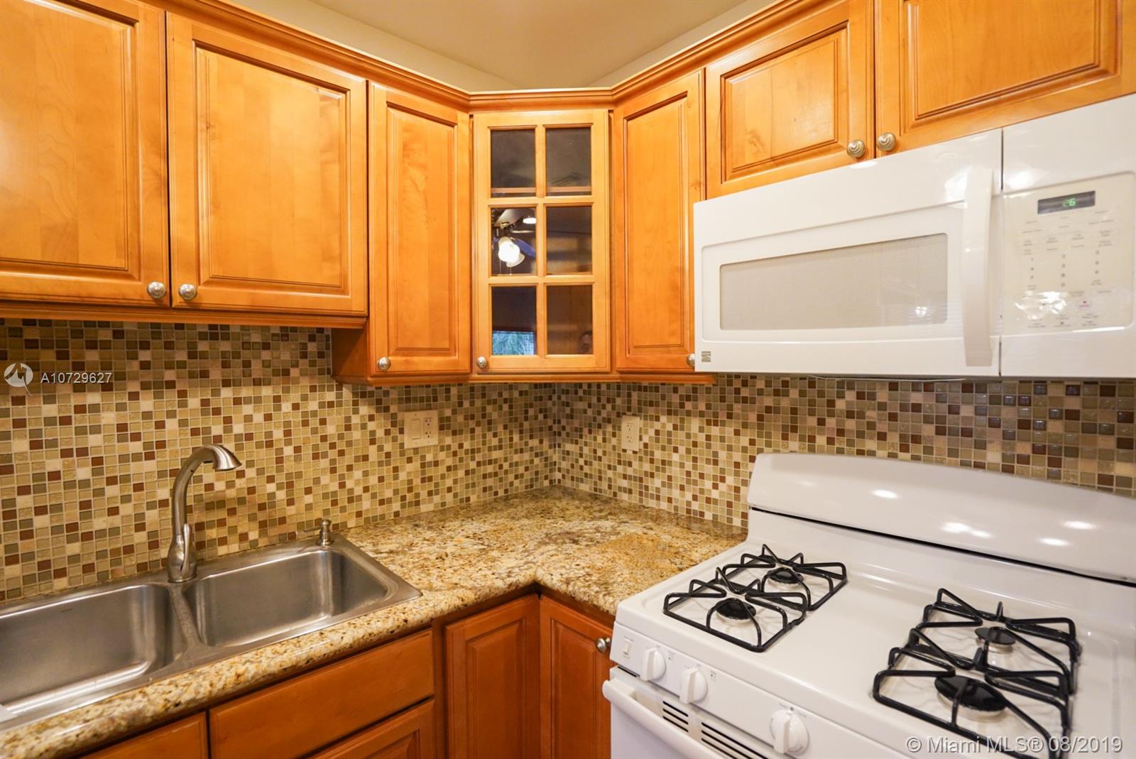 11501 Southwest 109th Road, Unit 13D Miami, FL 33176 - Photo 18 of 30 Kitchen - Dual sink, Gas Stove, Custom Cabinetry