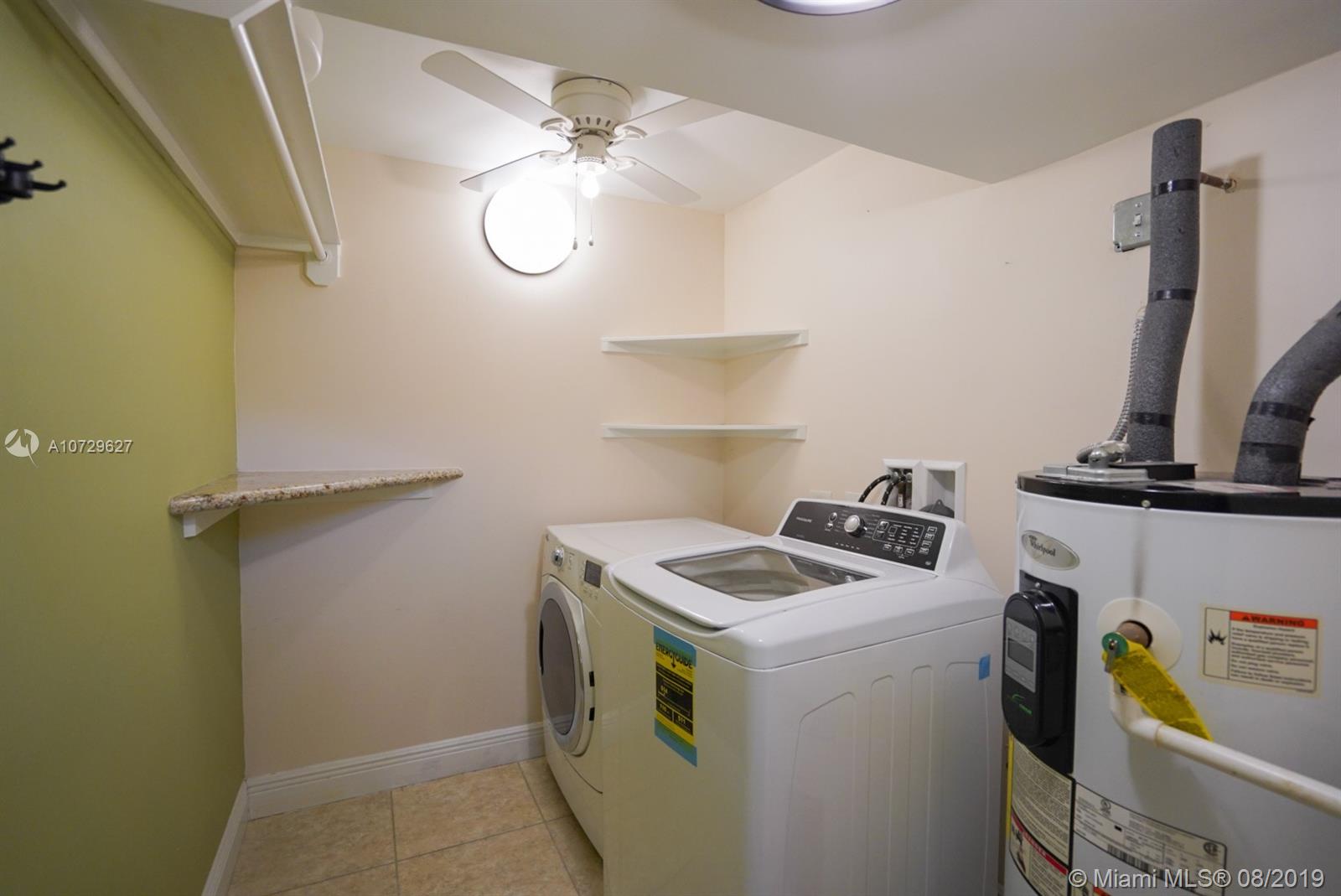 11501 Southwest 109th Road, Unit 13D Miami, FL 33176 - Photo 24 of 30 Laundry Room - Washer, Dryer, Water Heater, Shelving, Rods, Ceiling Fan - Newer appliances and Water Heater