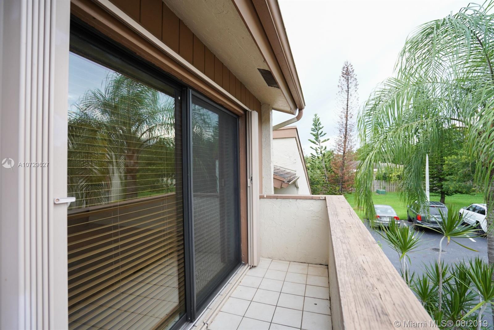 11501 Southwest 109th Road, Unit 13D Miami, FL 33176 - Photo 26 of 30 Balcony Patio with Shutters