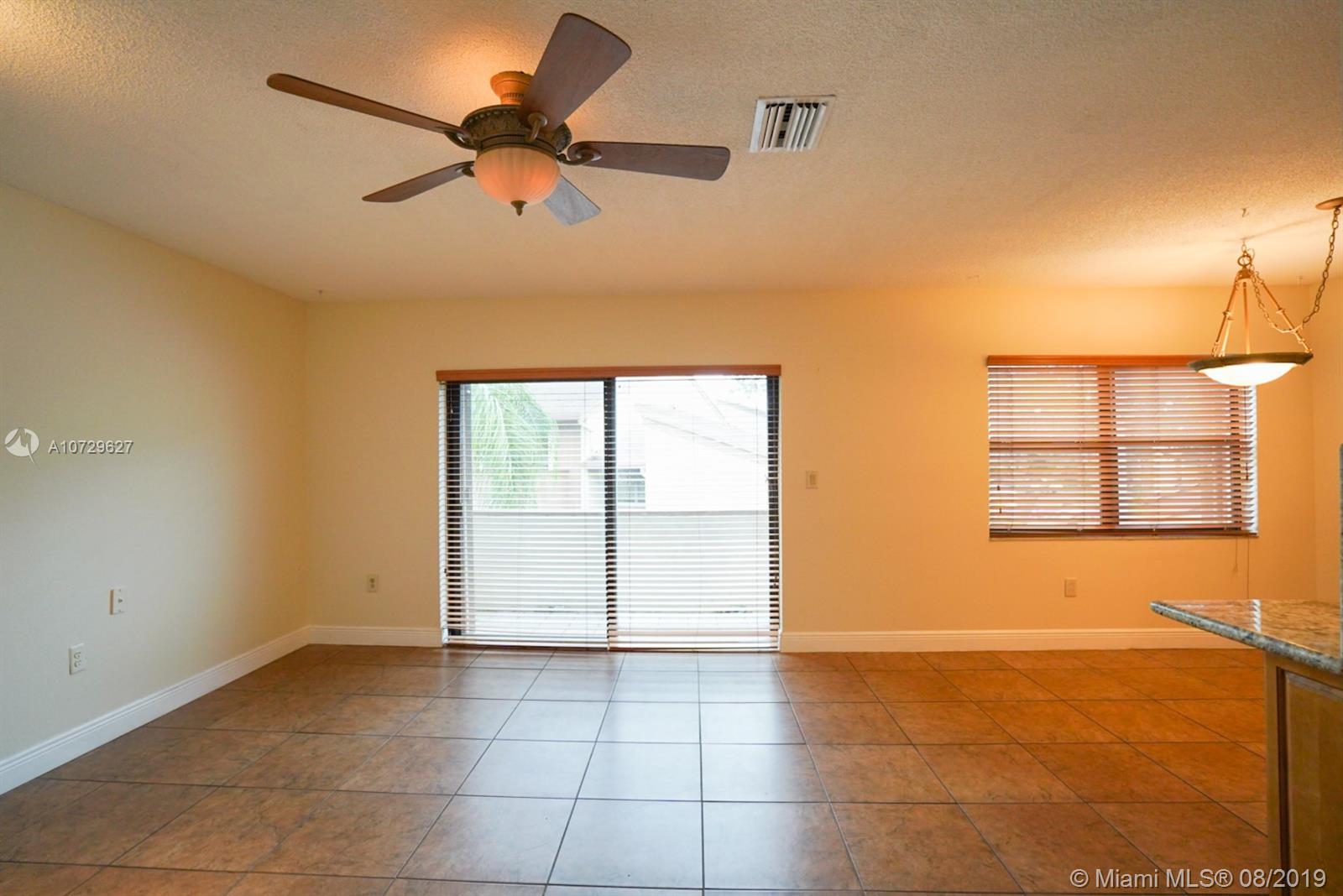 11501 Southwest 109th Road, Unit 13D Miami, FL 33176 - Photo 4 of 30 View of Living Room, Balcony Patio and Dining Area
