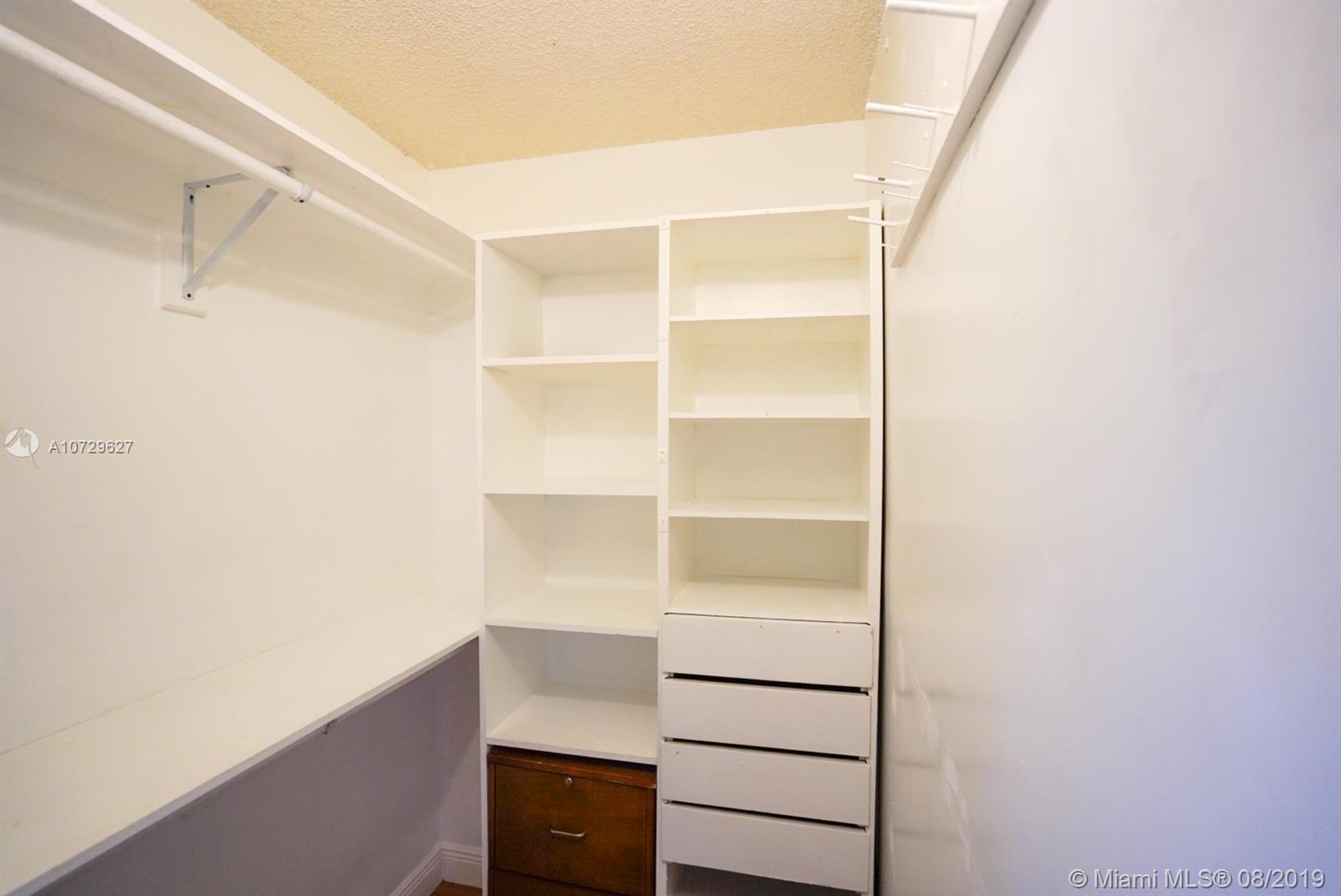11501 Southwest 109th Road, Unit 13D Miami, FL 33176 - Photo 8 of 30 Master Bedroom Walk-in Closet - closet rods, shelving, drawers