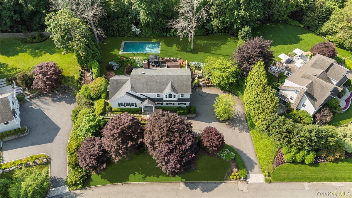 6 Halyard Court Cold Spring Harbor, NY 11724 - Photo 1 of 1 an aerial view of a house with garden space and a lake view
