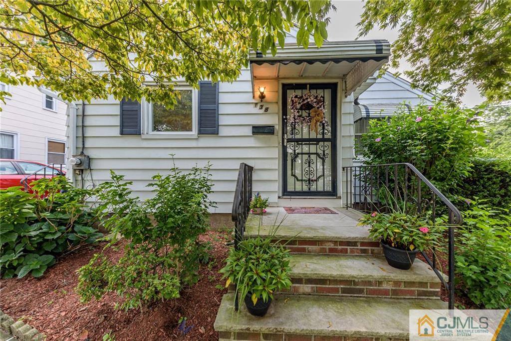 138 River Edge Road Bergenfield, NJ 07621 - Photo 1 of 28 a front view of a house with garden