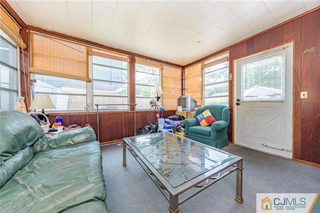 138 River Edge Road Bergenfield, NJ 07621 - Photo 19 of 28 a living room with furniture and a floor to ceiling window