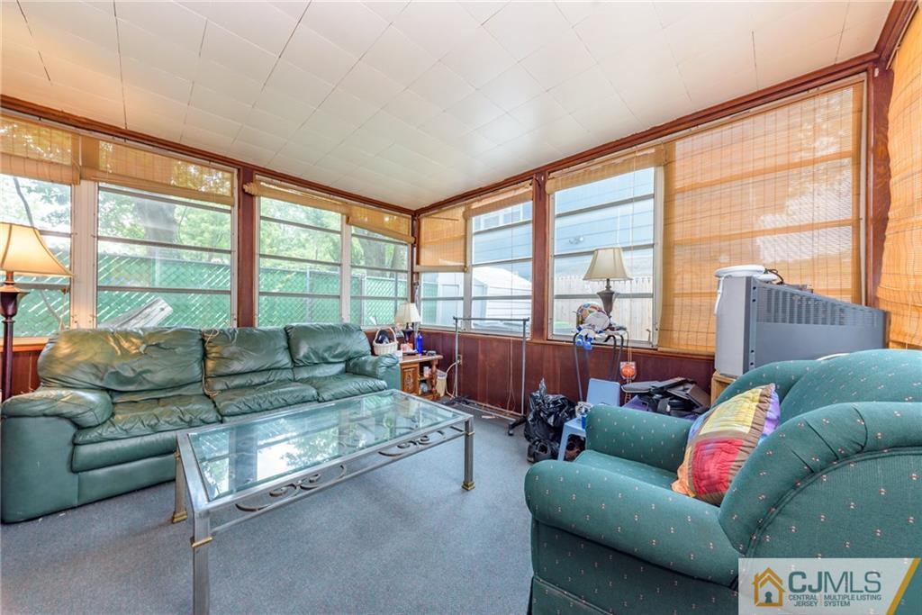 138 River Edge Road Bergenfield, NJ 07621 - Photo 20 of 28 a living room with furniture and a large window