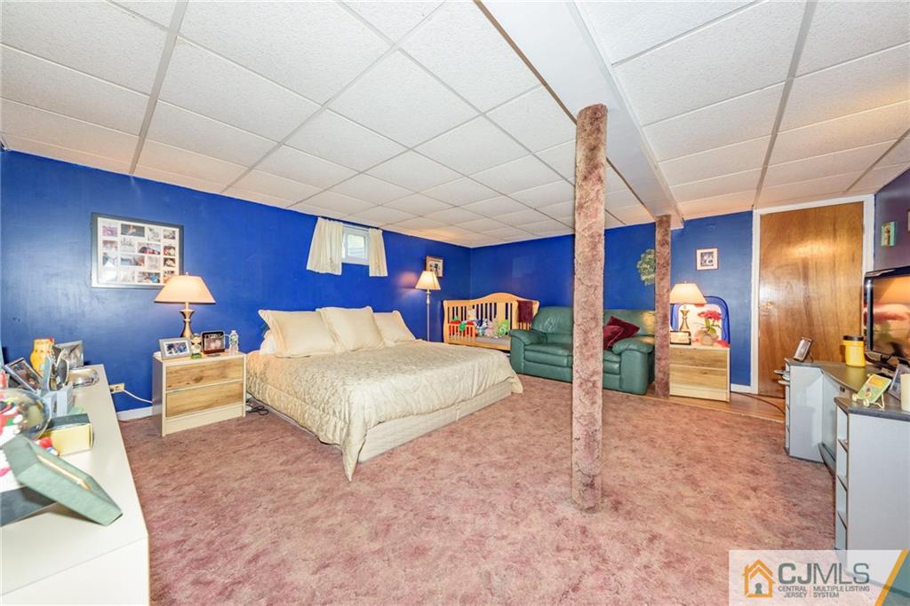 138 River Edge Road Bergenfield, NJ 07621 - Photo 22 of 28 a bed room with a bed and a couch