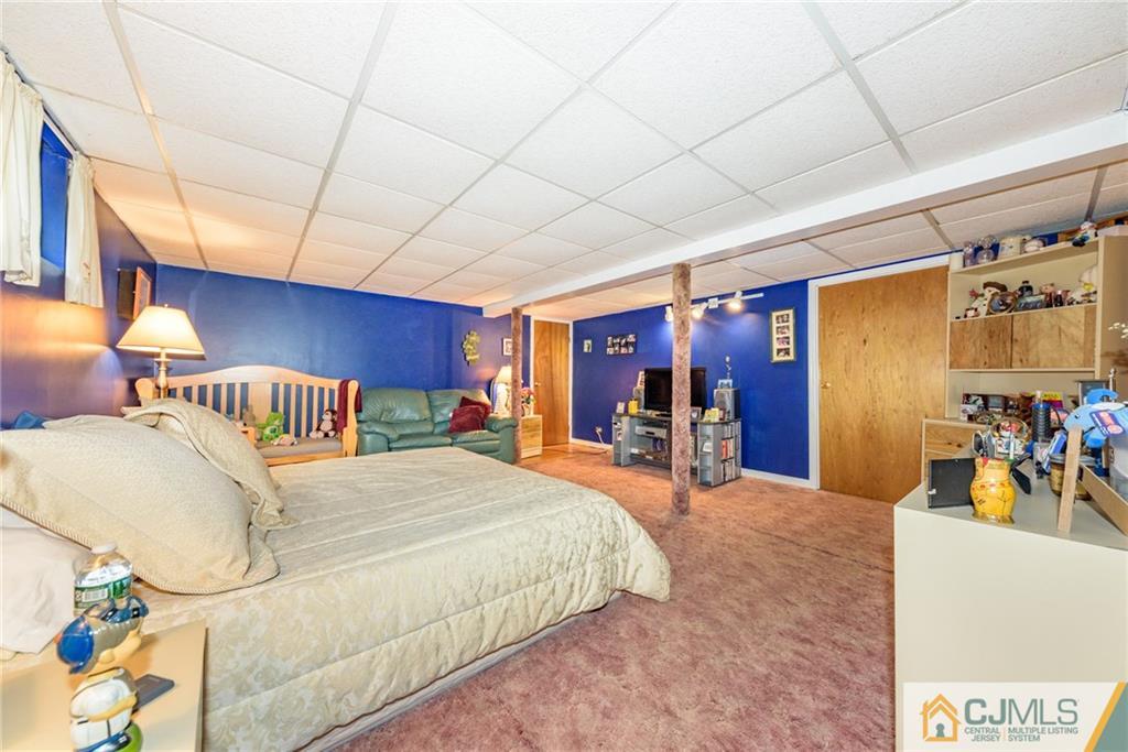 138 River Edge Road Bergenfield, NJ 07621 - Photo 23 of 28 a bedroom with a bed and a table