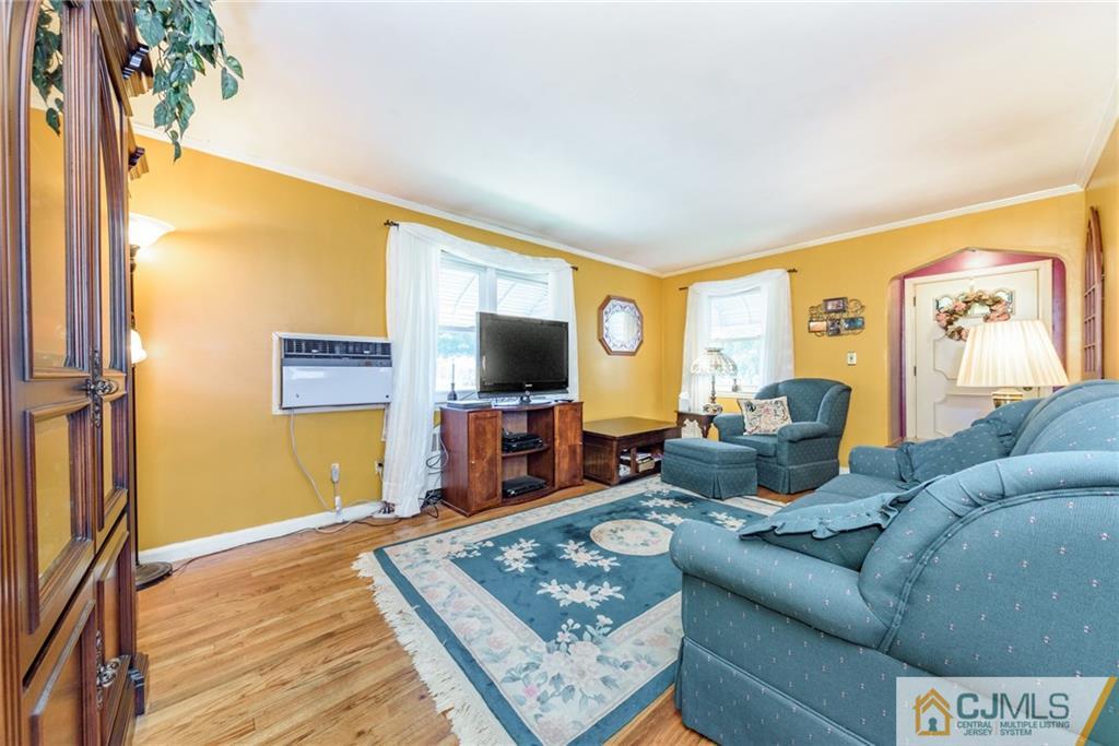 138 River Edge Road Bergenfield, NJ 07621 - Photo 4 of 28 a living room with furniture and a flat screen tv