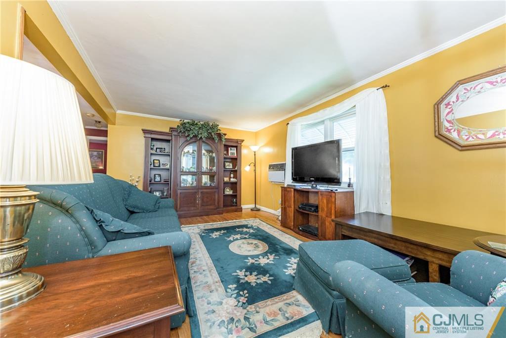 138 River Edge Road Bergenfield, NJ 07621 - Photo 5 of 28 a living room with furniture and a flat screen tv