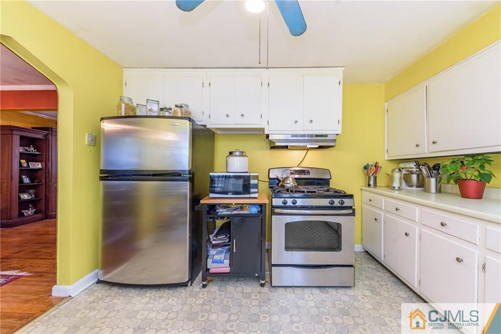 138 River Edge Road Bergenfield, NJ 07621 - Photo 10 of 28 a kitchen with stainless steel appliances granite countertop a refrigerator a stove and a sink