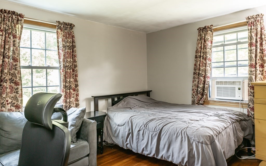 109 Oak Street Raynham, MA 02767 - Photo 12 of 25 a bed sitting in a bedroom next to a window