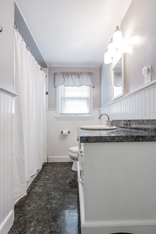 109 Oak Street Raynham, MA 02767 - Photo 16 of 25 a bathroom with a sink a mirror and a toilet