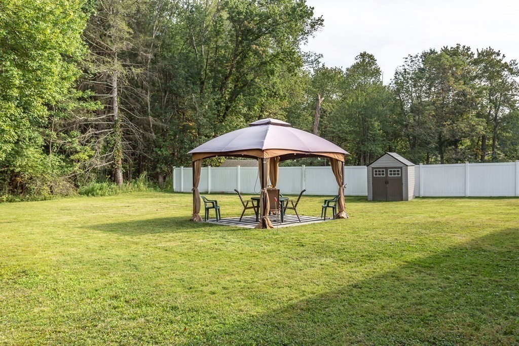 109 Oak Street Raynham, MA 02767 - Photo 20 of 25 a view of a swimming pool with lawn chairs under an umbrella