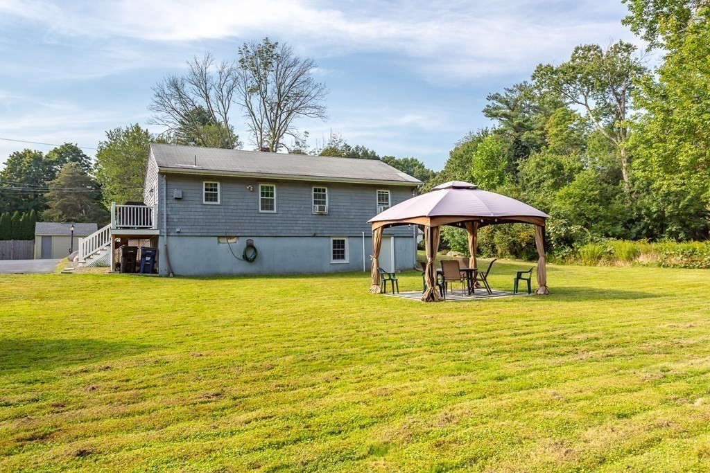 109 Oak Street Raynham, MA 02767 - Photo 22 of 25 a house that has a swimming pool in front of it