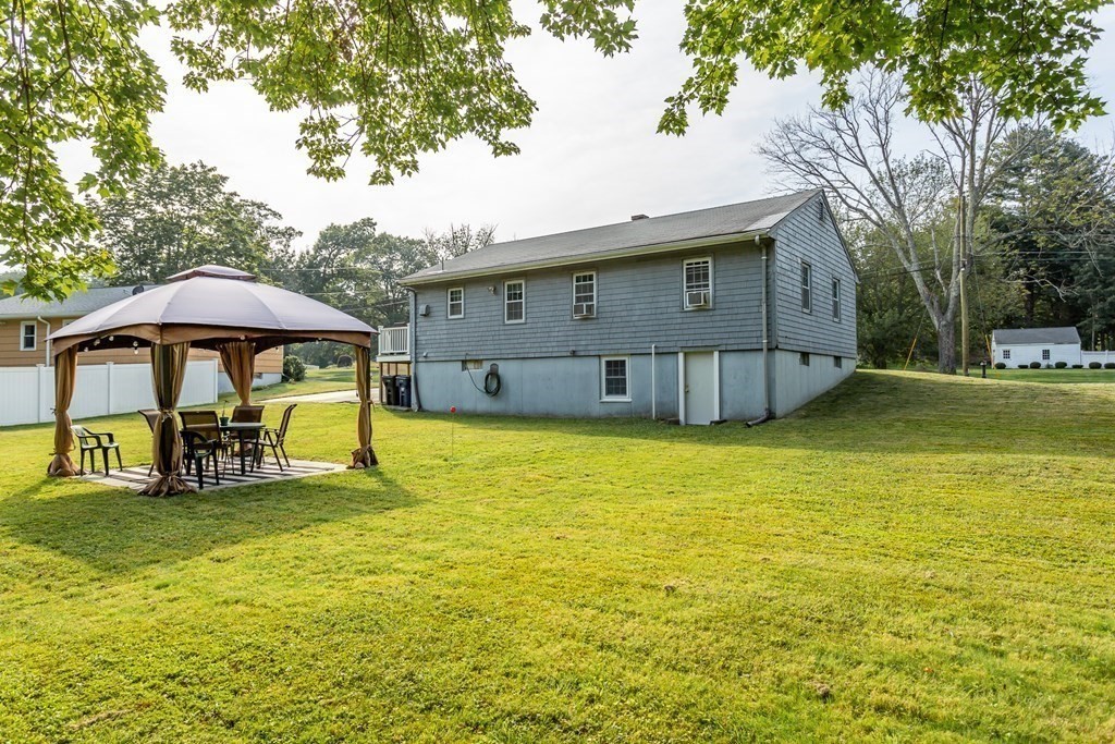 109 Oak Street Raynham, MA 02767 - Photo 23 of 25 a view of a swimming pool with lawn chairs under an umbrella