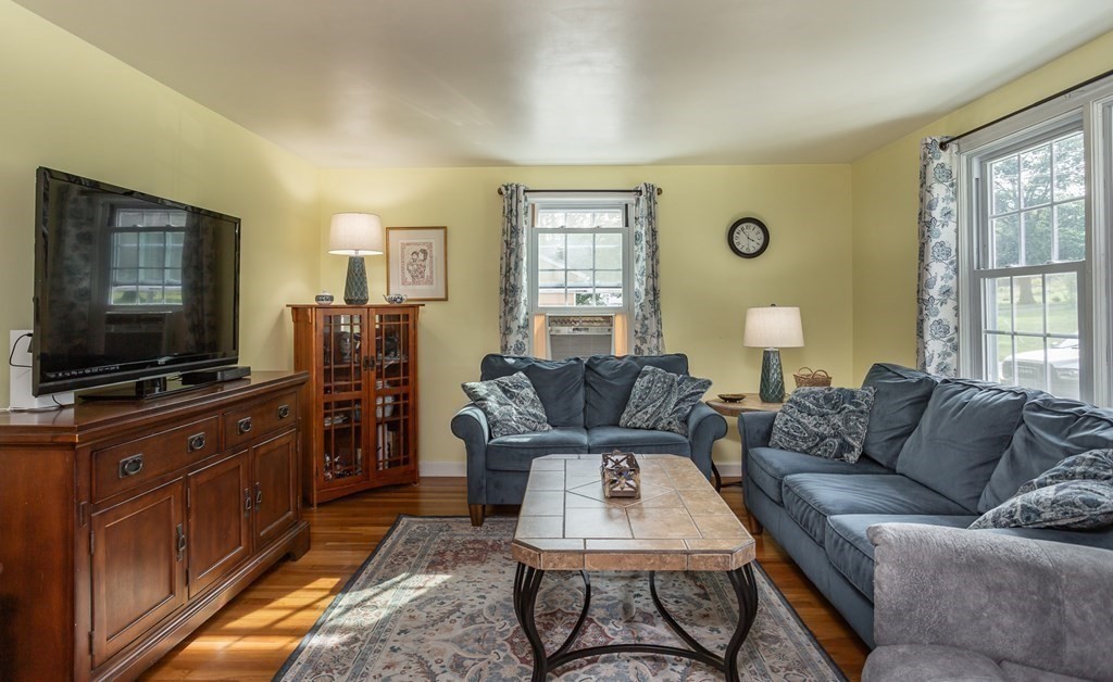 109 Oak Street Raynham, MA 02767 - Photo 8 of 25 a living room with furniture and a flat screen tv