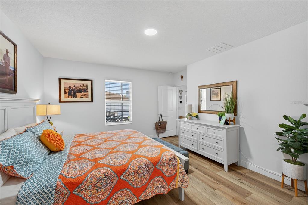 94 Rose Bud Ln Spring Hill Spring Hill, FL 34609 - Photo 17 of 38 a bedroom with a bed and a dresser in it