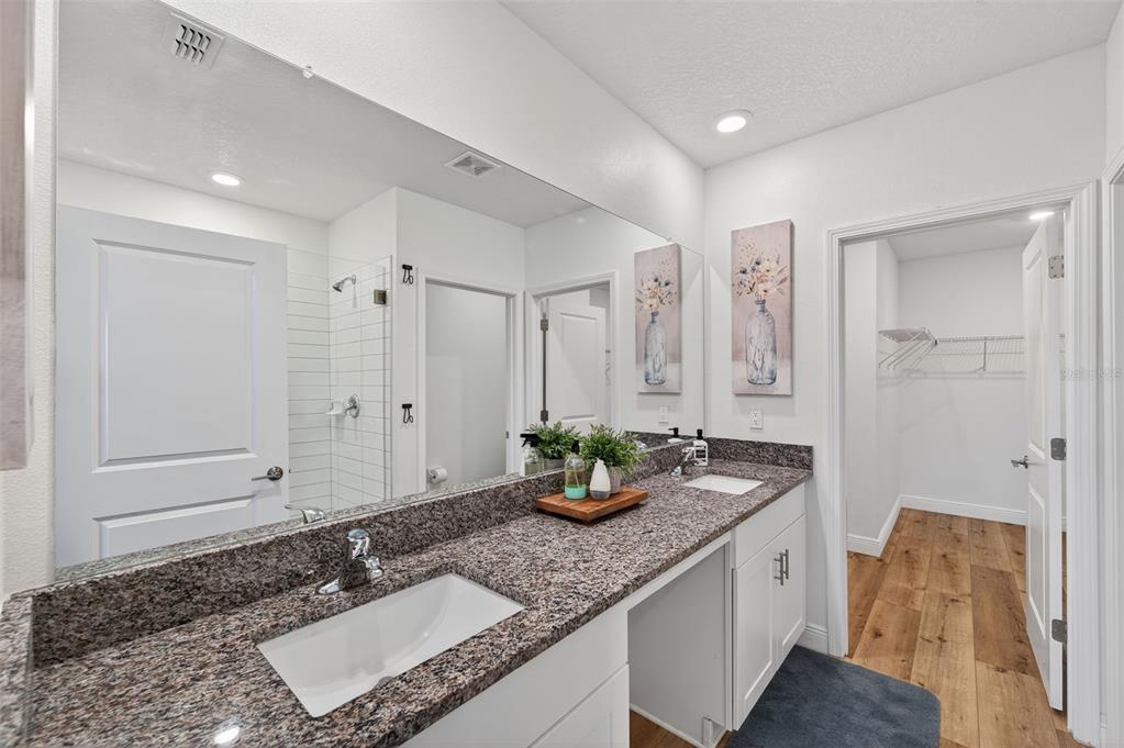 94 Rose Bud Ln Spring Hill Spring Hill, FL 34609 - Photo 18 of 38 a bathroom with a granite countertop sink and a mirror