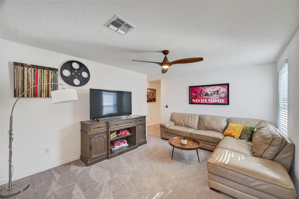 94 Rose Bud Ln Spring Hill Spring Hill, FL 34609 - Photo 21 of 38 a living room with furniture and a flat screen tv