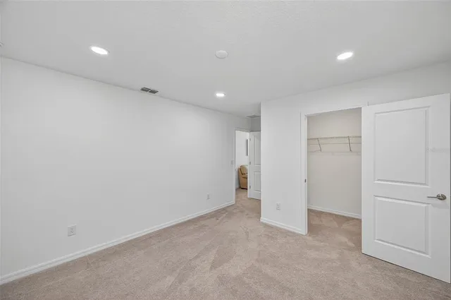 a bedroom with furniture and a flat screen tv