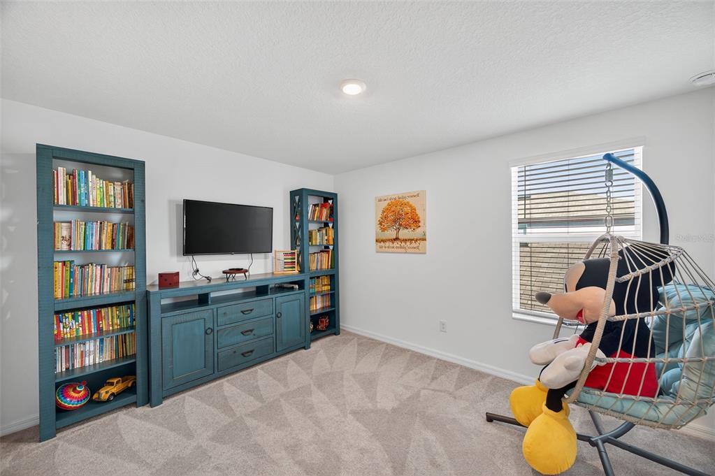 94 Rose Bud Ln Spring Hill Spring Hill, FL 34609 - Photo 24 of 38 a bedroom with furniture and a flat screen tv