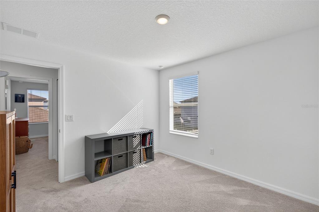 94 Rose Bud Ln Spring Hill Spring Hill, FL 34609 - Photo 27 of 38 a room with furniture and a window