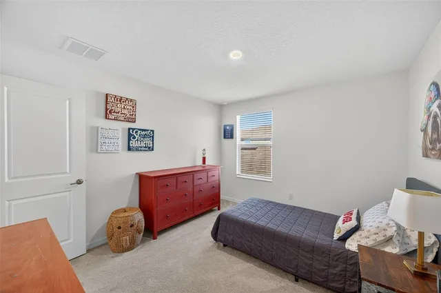 a bedroom with furniture and a wooden floor
