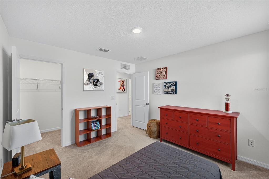 94 Rose Bud Ln Spring Hill Spring Hill, FL 34609 - Photo 30 of 38 a room with furniture and a bed