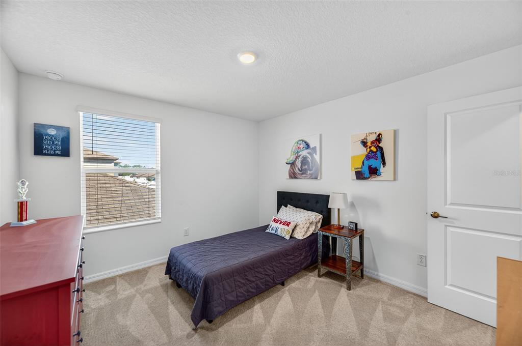 94 Rose Bud Ln Spring Hill Spring Hill, FL 34609 - Photo 31 of 38 a bedroom with a bed and a window