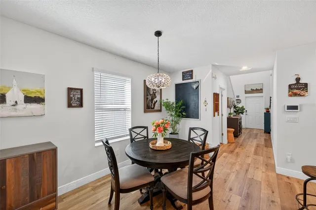 a view of a dining room with furniture window and wooden floor