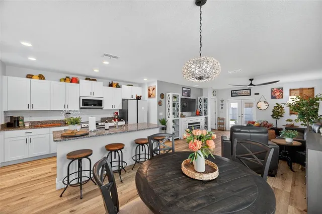 a kitchen with stainless steel appliances kitchen island granite countertop a sink and cabinets