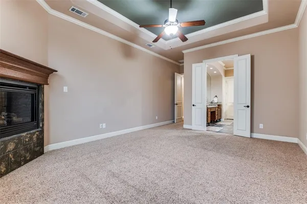 an empty room with a ceiling fan and window